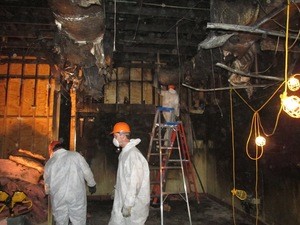 Water Damage Restoration Technician Working In Basement