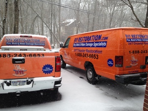 Water Damage Restoration Truck And Van At Winter Job Site