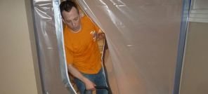 Water and Mold Damage Restoration Technician Using Air Mover Near Vapor Barrier